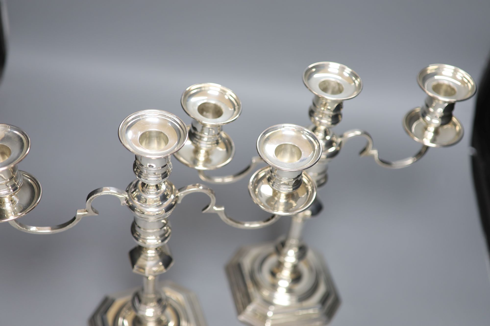 A pair of George I style silver two-branch three-light candelabra, Birmingham 1967, Makers: Elkington & Co,